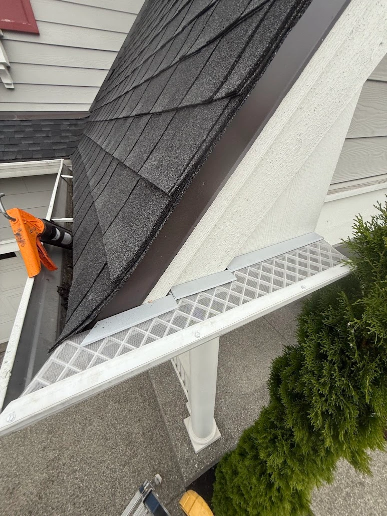 Complex gutter guard installation spanning multiple roof planes