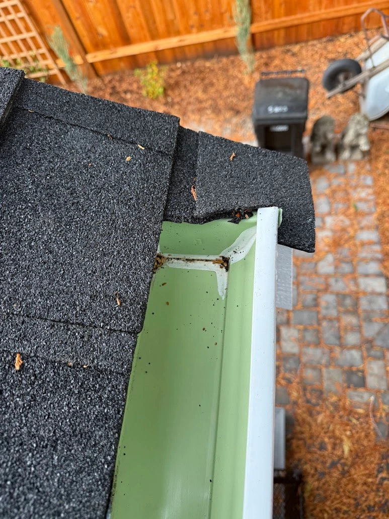 Open gutter seam leaking along a Seattle fascia before resealing