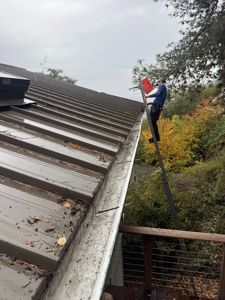 Osprey Exterior technician readjusting gutter height on a ladder